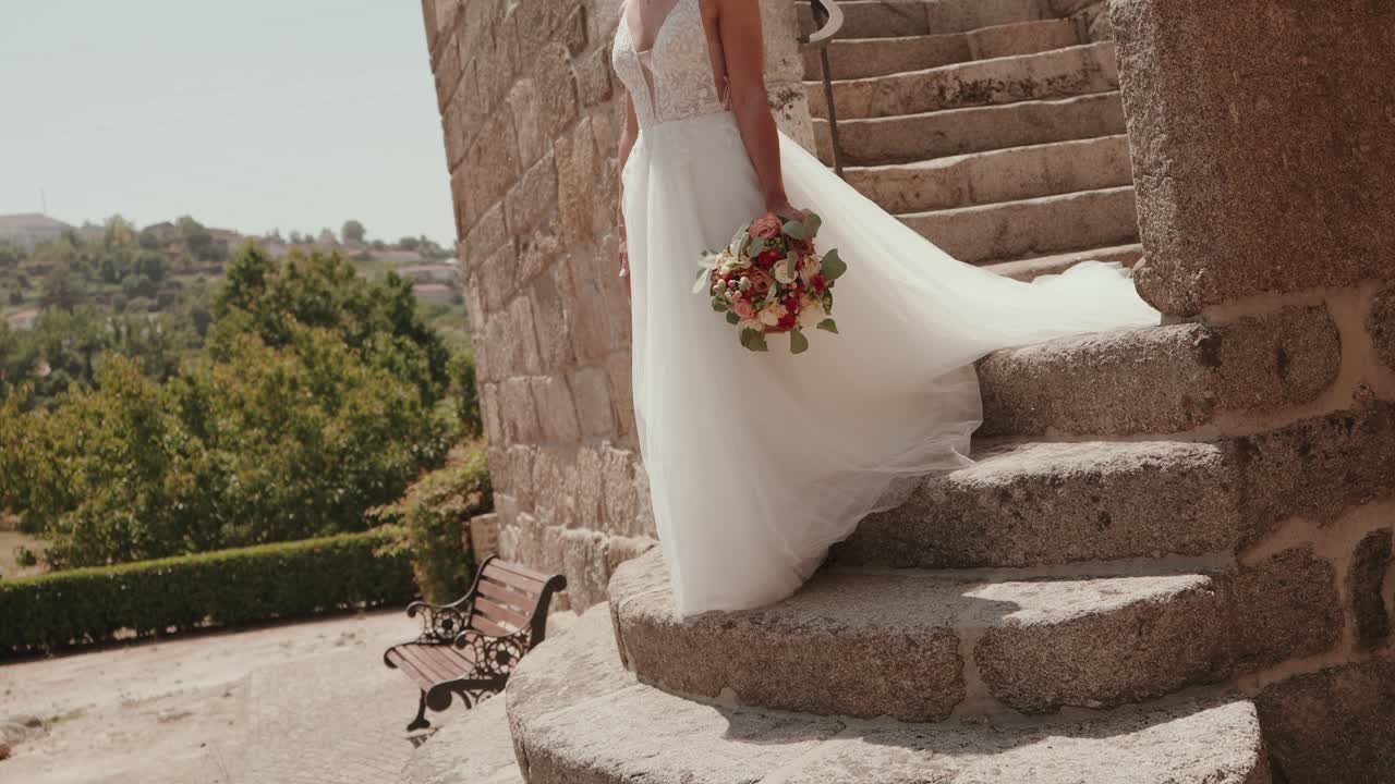 wedding dress and bouquet captured on rustic stone steps