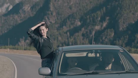 young-brunette-in-black-leather-jacket-sits-on-car-window