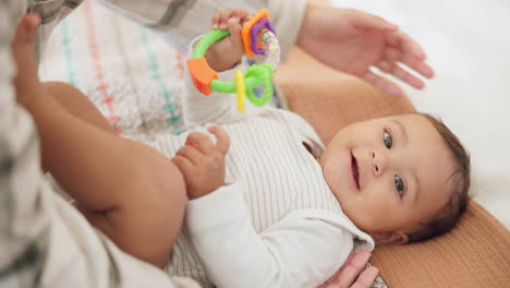 baby child, parent and rattle on bed with mama