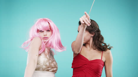 Girlfriends-dancing-wearing-red-dress-and-pink-hair-in-slow-motion-party-photo-booth