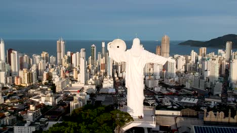 Aerial-view-of-christ-the-redeemer-in-Balneario-camboriu-with-the-city-and-beach-on-the-background