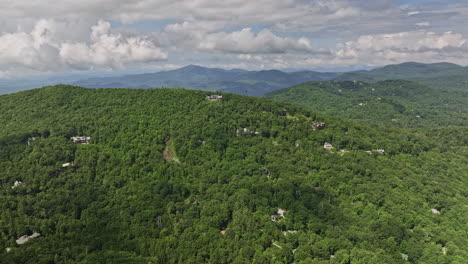Highlands-North-Carolina-Aerial-v17-drone-flyover-hillside-neighborhood-capturing-lush-green-forests,-mountainous-nature-landscape-and-town-center-during-summer---Shot-with-Mavic-3-Cine---July-2022