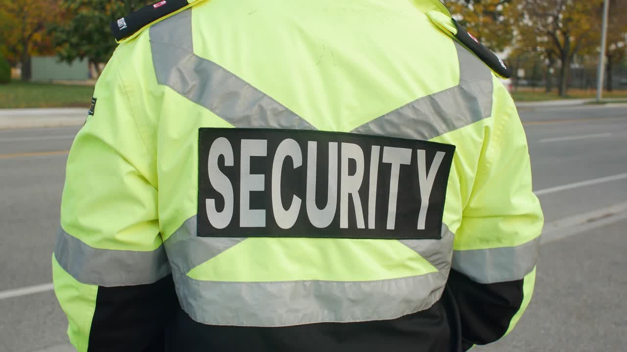 Security guard in uniform patrolling in a commercial area