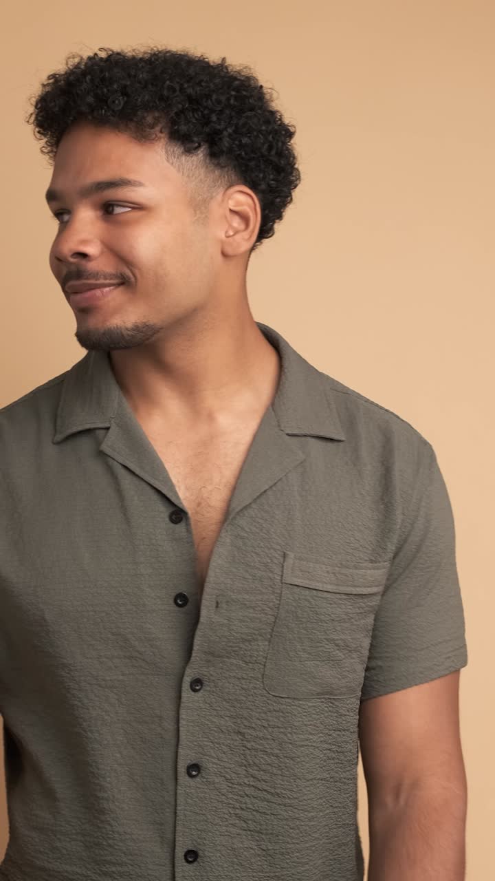 Positive man standing with satisfied expression on face