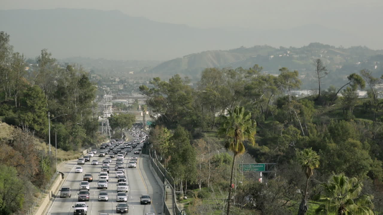 A busy California highway at rush hour on a sunny day.