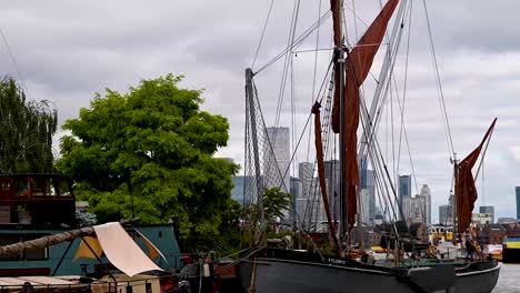 time-lapse of a boat at canary wharf with city of london skyline in the background on a clear summer's day