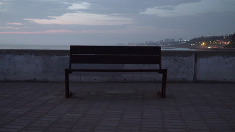 sunset over empty bench in jetty in miraflores, lima, per?