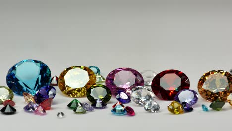 colorful diamonds of various sizes glittering on a white background.