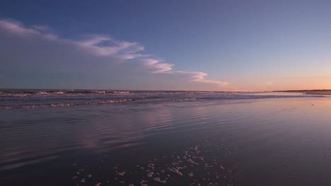 Waves-rolling-to-the-sand-under-a-purple-night-sky-wide-angle