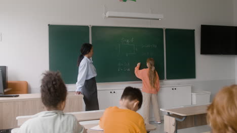 Lehrer-Und-Schüler-An-Der-Tafel.