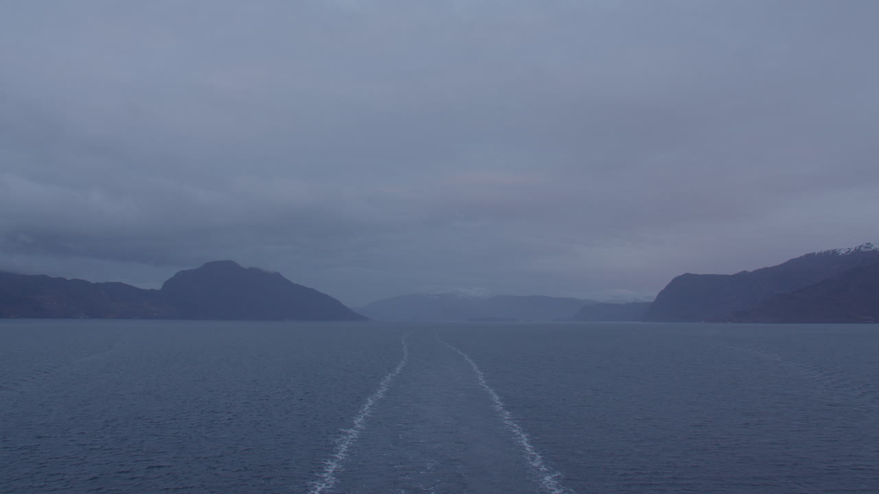 time lapse shot of the back of the ship transiting Hardanger, Hardangerfjorden Fjord in Early morning