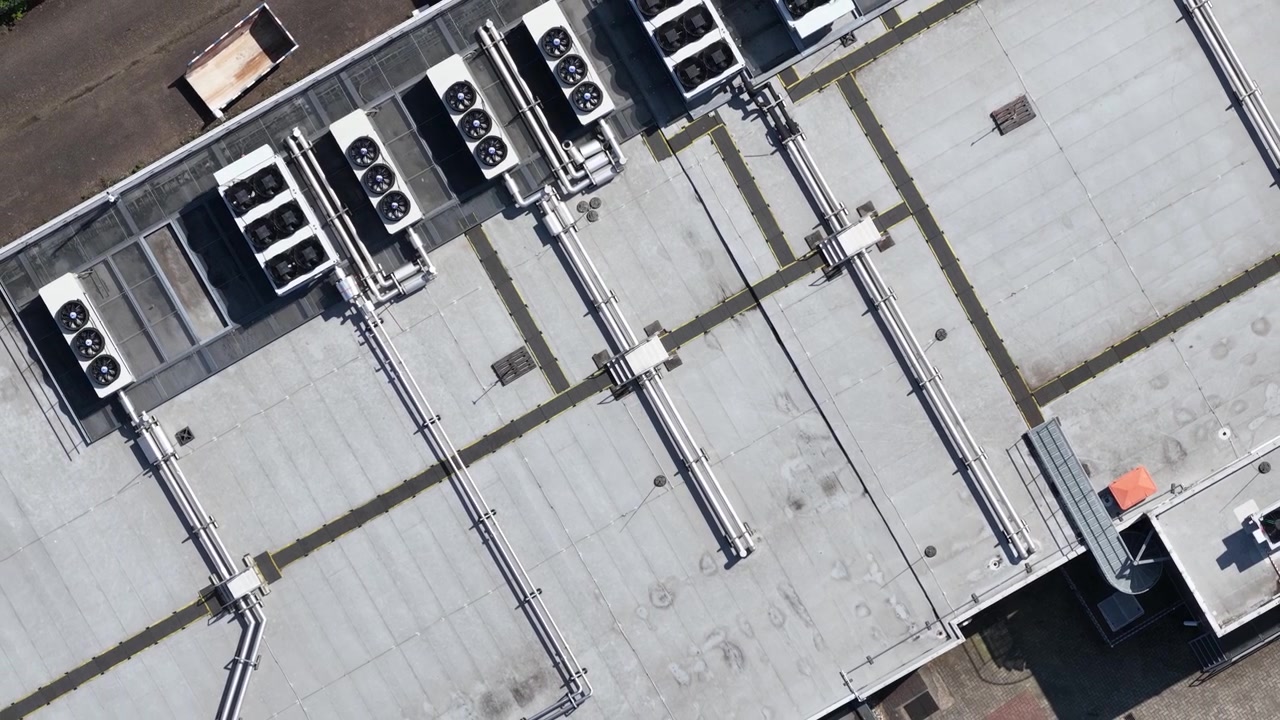 erial view of large scale data center rooftop HVAC cooling systems, showing colocation infrastructure, cloud computing, big data, machine learning and AI hardware technology.