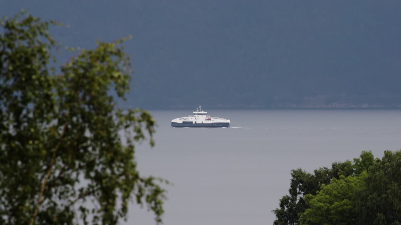 Ferry Boat Sailing on Calm Fjord with Mountains in Background