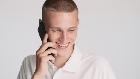 smiling man talking on the phone