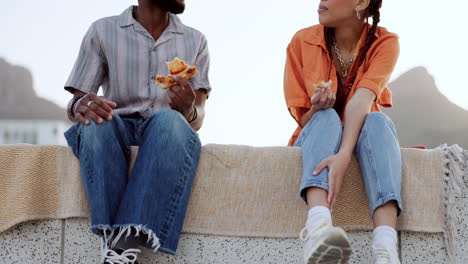 couple, pizza and talking outdoor on city building