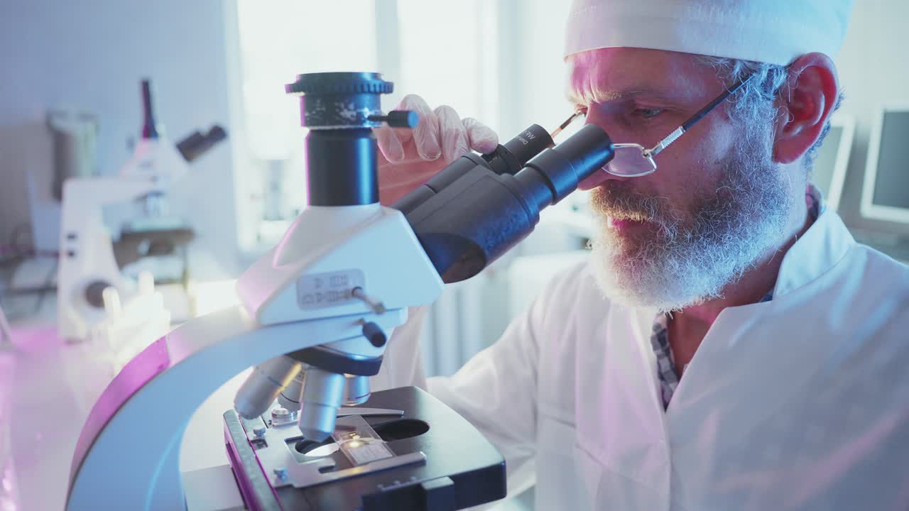 Focused Scientist Working with Microscope in Modern Laboratory
