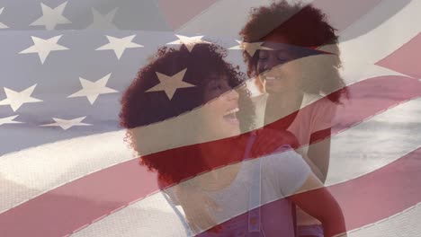 Animation-of-flag-of-united-states-of-america-over-happy-african-american-mother-with-daughter