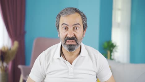 hombre de mediana edad mirando a la cámara con enojo.
