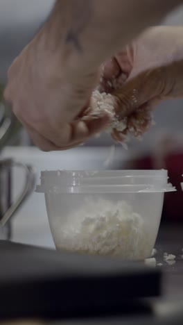 hands mixing food ingredients in a container