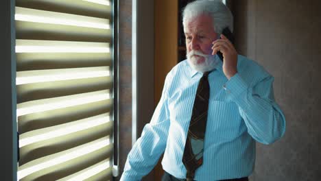 upset company manager talks on the phone in the office. angry business male screaming during phone call