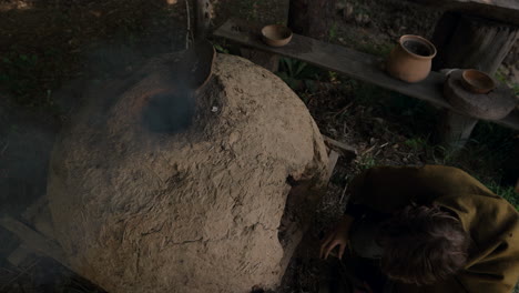 preparing food in a traditional earth oven