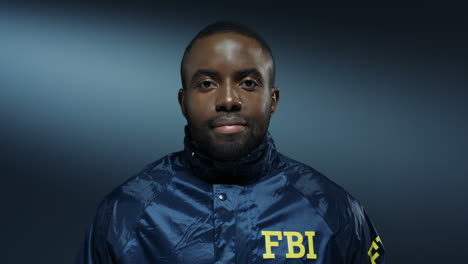 Portrait-Of-The-Young-Cheerful-Fbi-Agent-Smiling-To-The-Camera-With-Sincere-Eyes