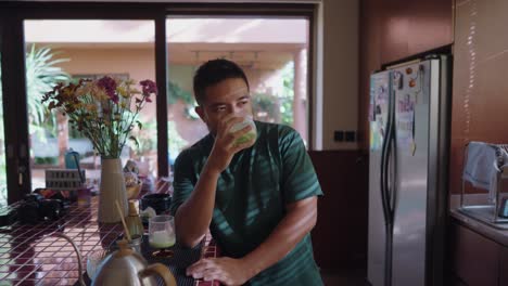 man enjoying matcha in a cozy kitchen