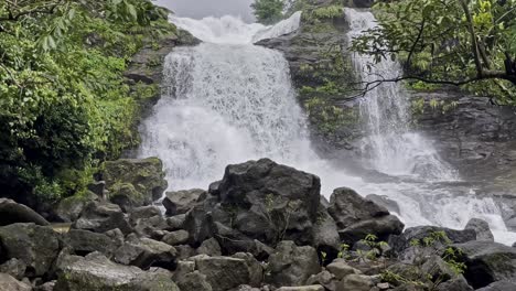 a stunning waterfall cascades down rocky cliffs at bhandardara, maharashtra, india, surrounded by lush greenery with monsoon aura 4k