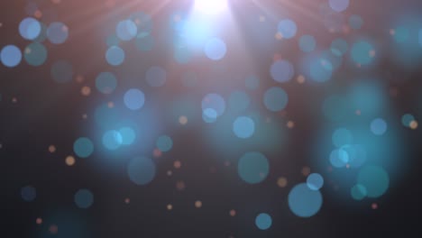 gran bokeh redondo azul con rayos de sol en un fondo oscuro