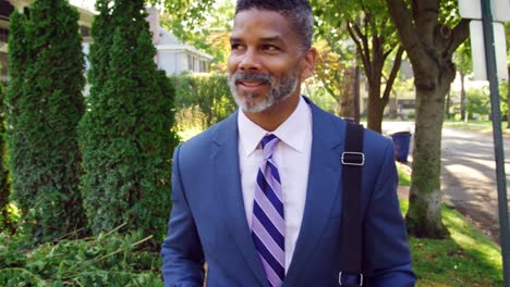 Businessman-With-Cup-Of-Coffee-Walks-Along-Suburban-Street