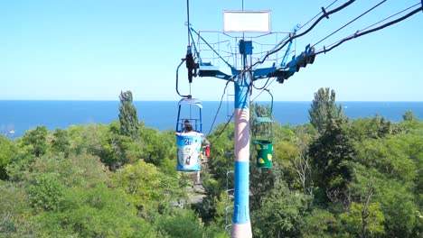 ropeway with blue sea and green trees on backgroud