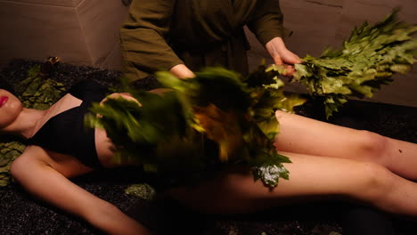 woman receiving a traditional russian banya treatment