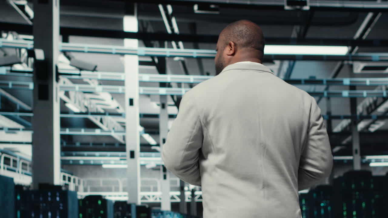 Vertical video Data center system administrator checks infrastructure diagnostics using tablet