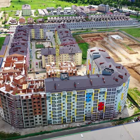 modern construction area in the city. new residential complex is building in summer. tower crane in a construction site