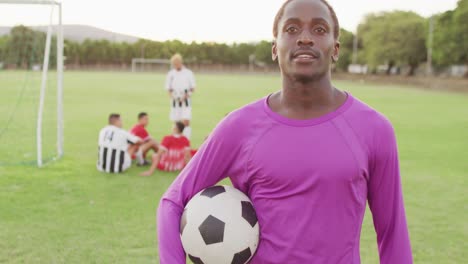 Video-of-african-american-football-player-on-field-with-ball