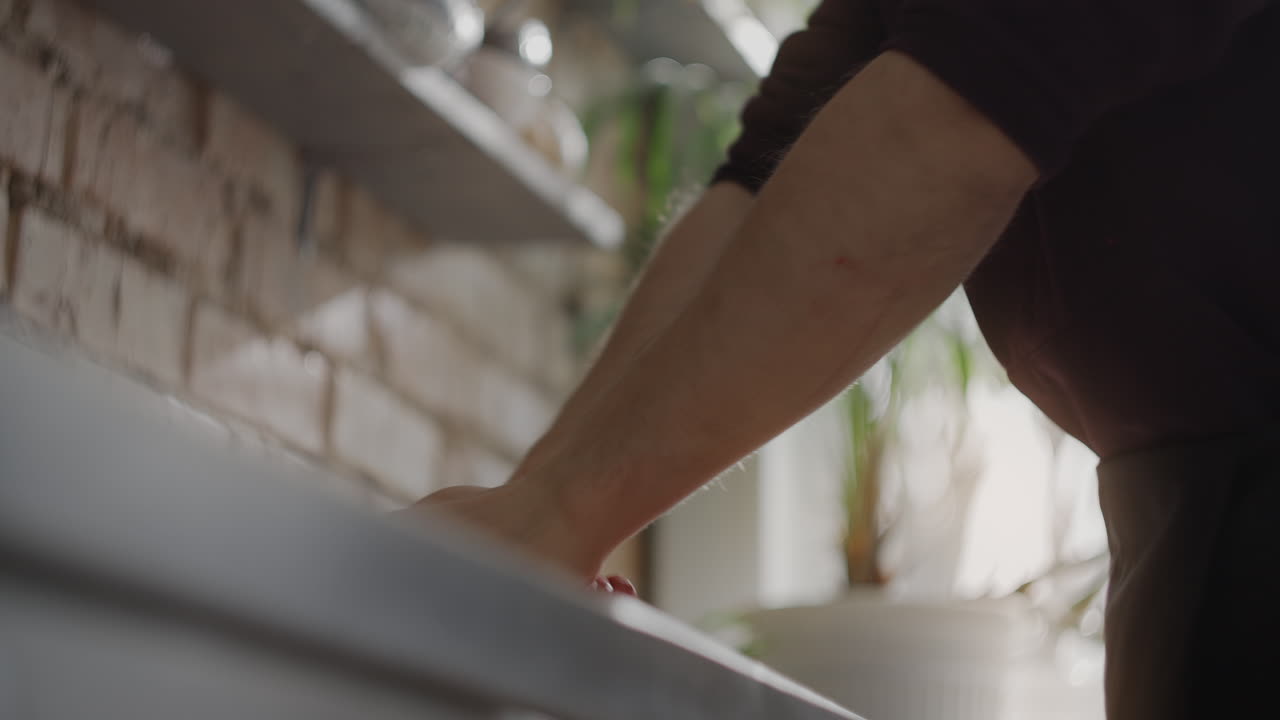 Person Cleaning Kitchen Counter