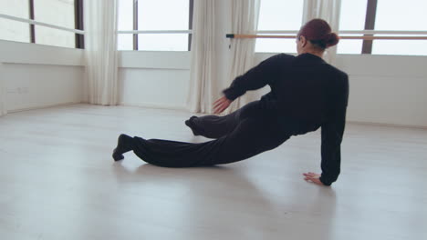 talented female dancer practicing floor work at the studio