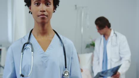 Front-view-of-African-american-female-doctor-using-digital-tablet-in-the-ward-at-hospital-4k