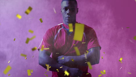 animation of confetti falling over african american male player with arms crossed