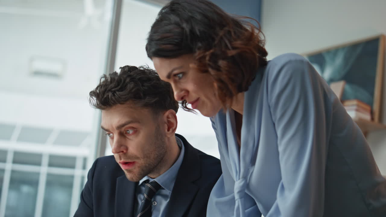 Woman secretary bringing document to serious businessman in office desk closeup