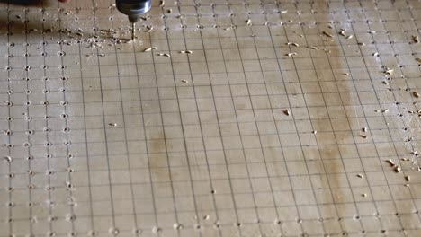 drilling a pattern of holes using a power tool and guided by grid lines