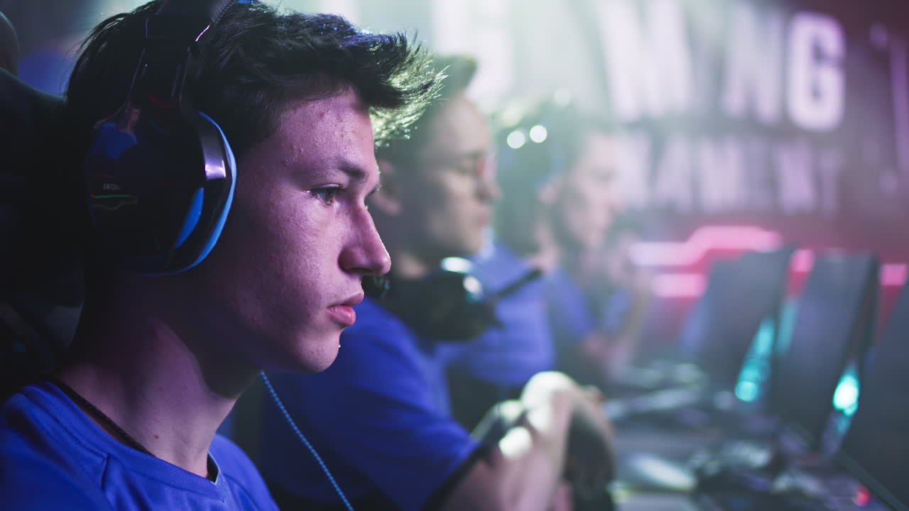 nervous Teenager Preparing to Play Video Game Anxious Teen Esportsman Gamer Touching Face and Putting on Headphones then Bumping Fists with Teammate at Start of Professional Gaming Competition