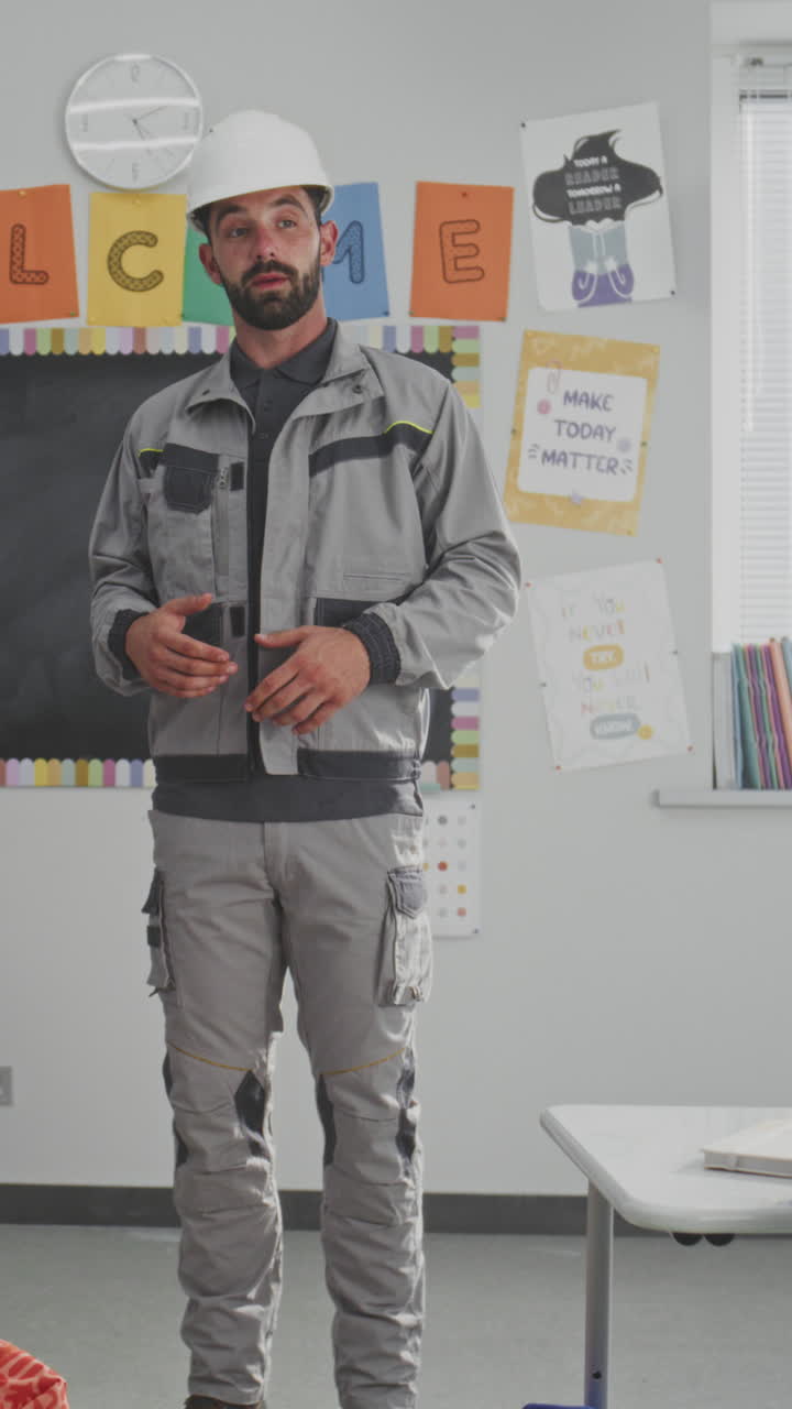 Engineer in Uniform Speaking and Giving Lecture to Curious Primary School Students About Engineering