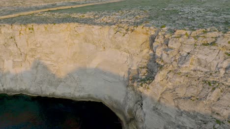 Aerial-of-sea,-cliffs,-and-rock-formations-at-Sa-Falconera,-Menorca