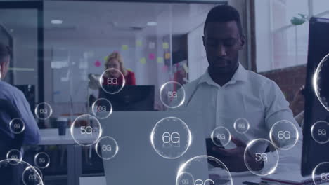 animation of 6g texts over african american man using laptop