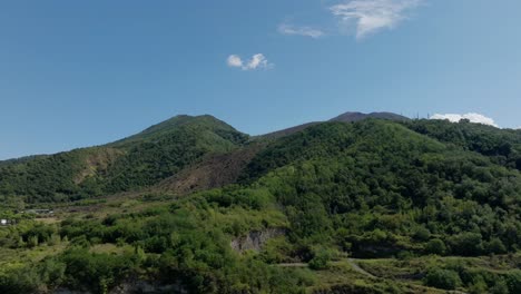 aerial 4k shot along green mountain ridge line in napoli during summer time