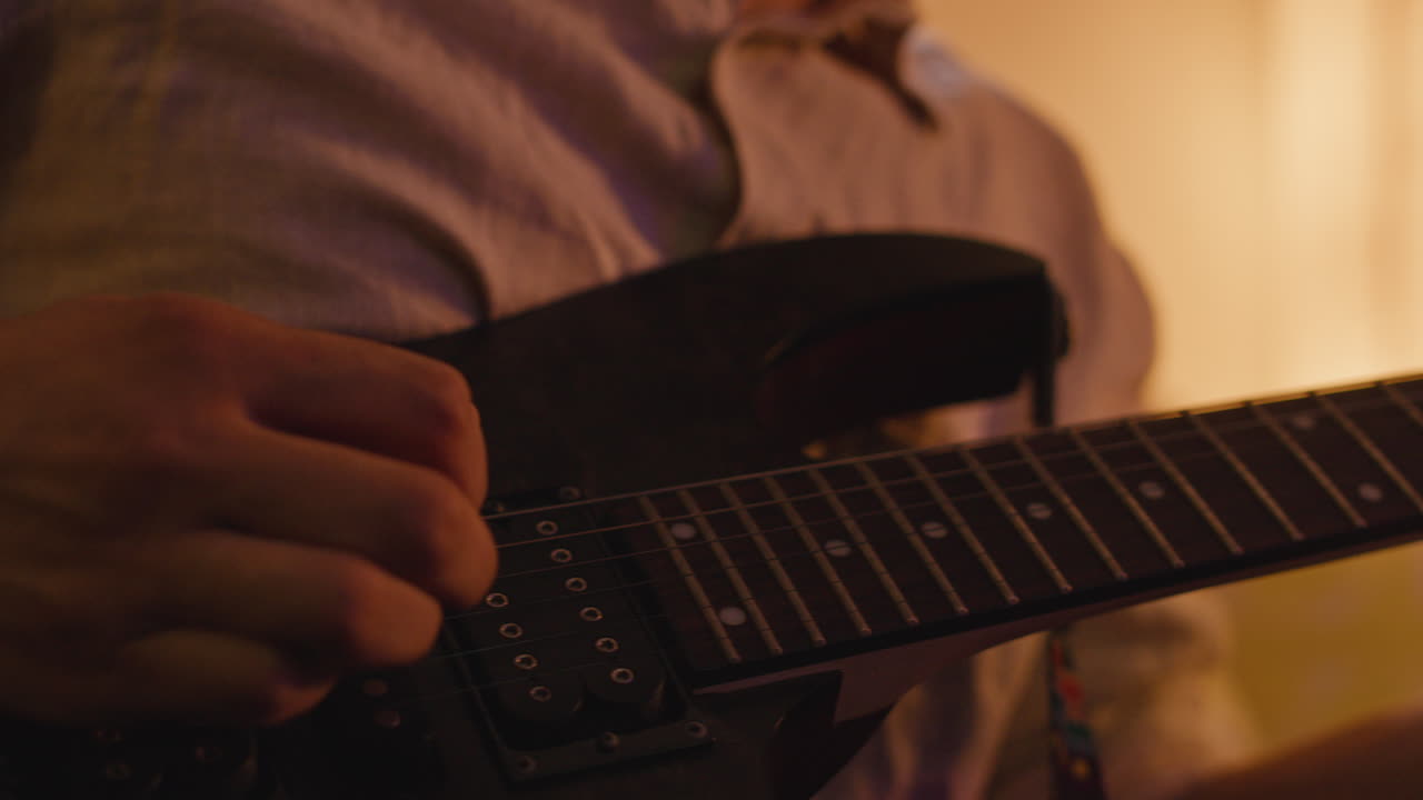 Close-up of guitar player performing