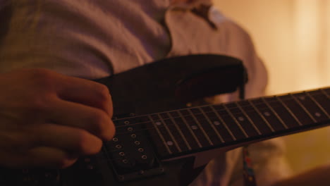 close-up of guitar player performing