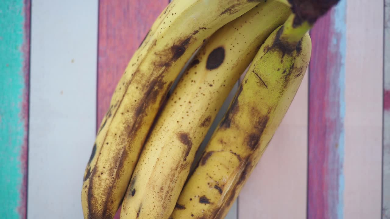 Bunch of Slightly Ripe Bananas on a Wooden Surface