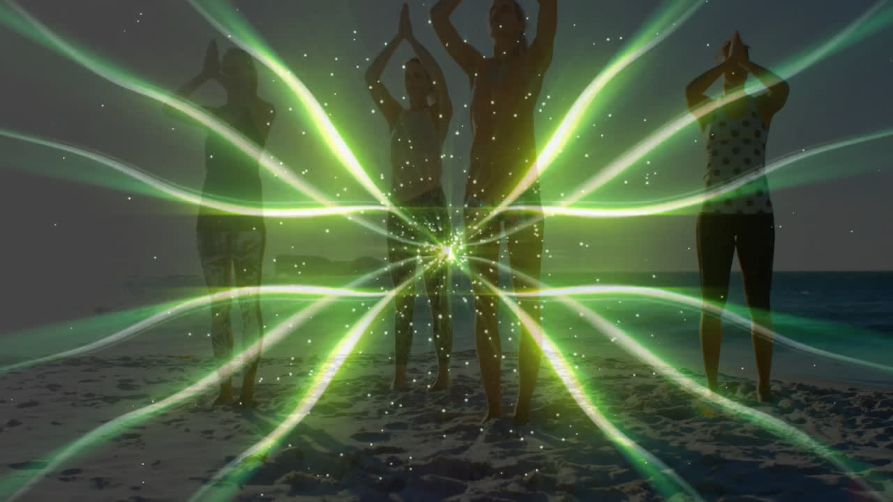 People practicing yoga on beach with green light pattern animation over them